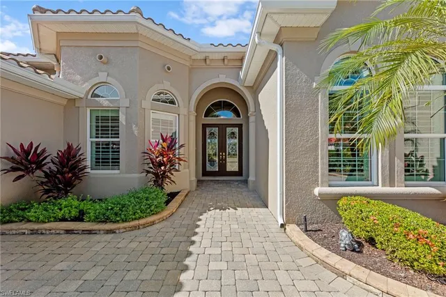 a front view of a house with plants