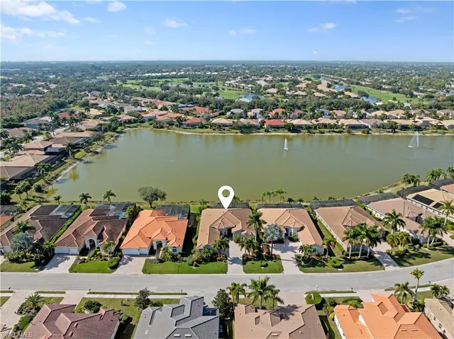 an aerial view of a house with a lake view and mountain view