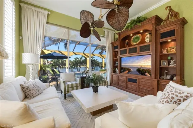 a living room with furniture a chandelier and a large window