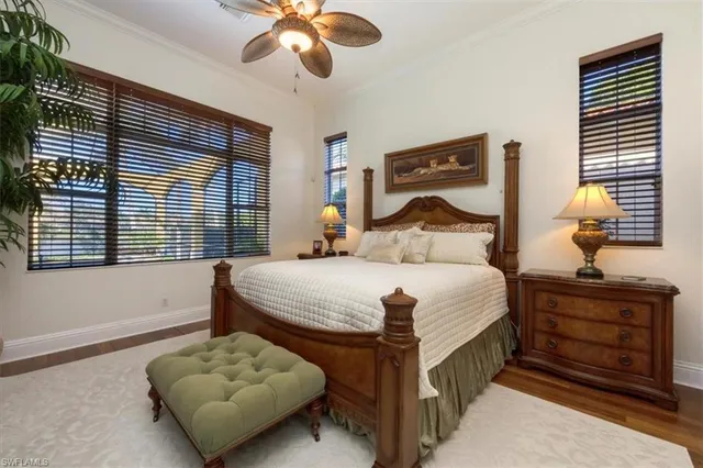 a bedroom with a bed and dresser with mirror