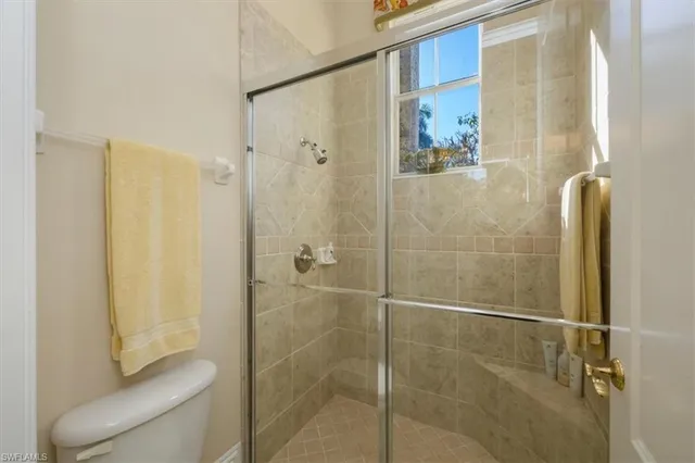 a bathroom with a shower and a toilet
