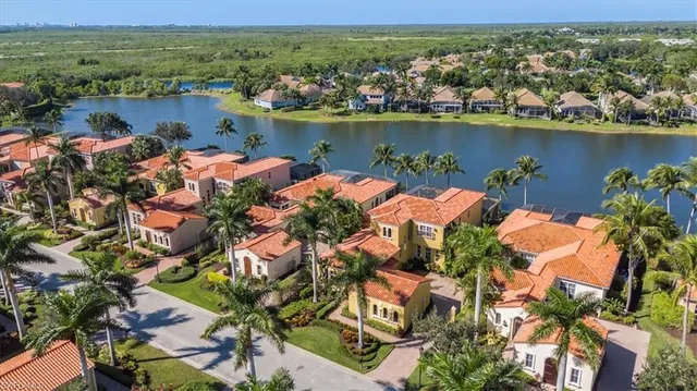 an aerial view of a houses with a lake view