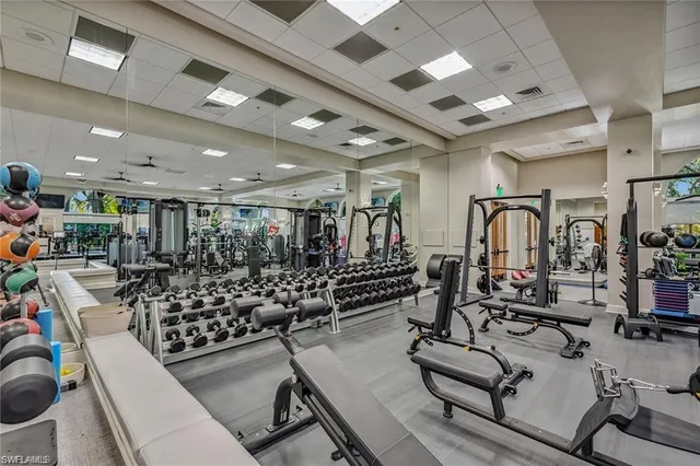 a room with gym equipment and lots of wooden floor