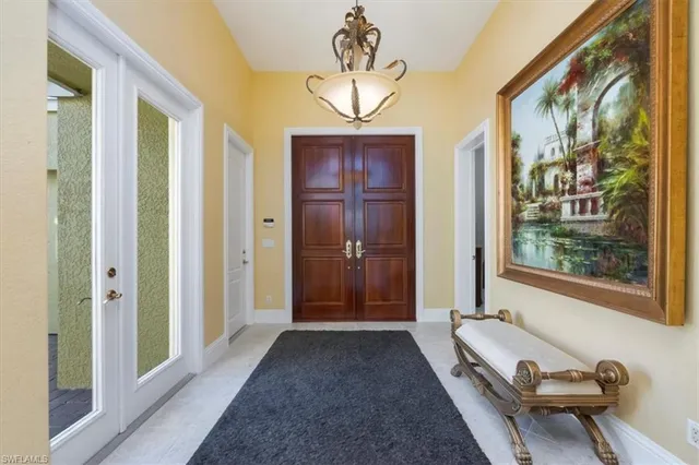 a view of a hallway with furniture and a window