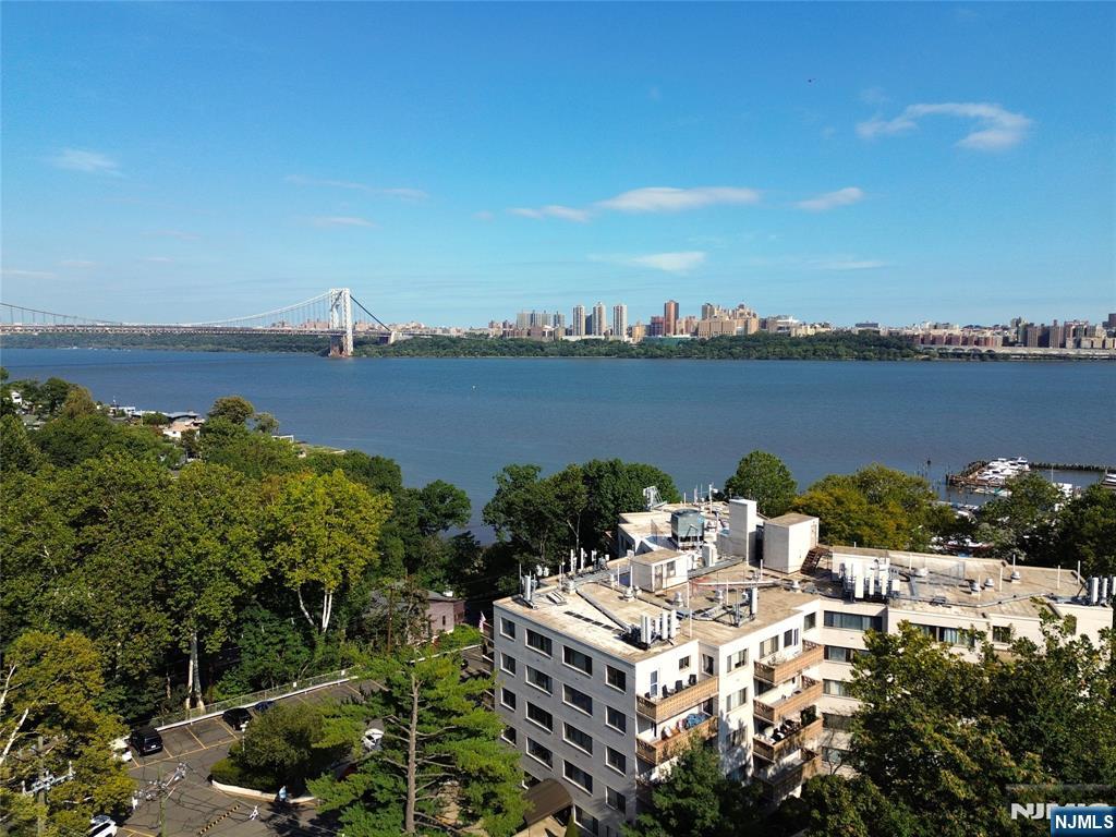 1375 River, Unit LG Edgewater, NJ 07020 - Photo 1 of 18 a view of a lake with a mountain view