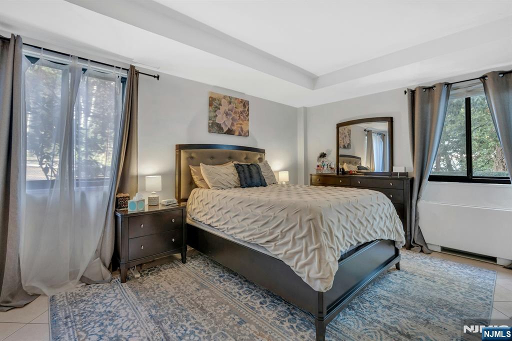 1375 River, Unit LG Edgewater, NJ 07020 - Photo 13 of 18 a bedroom with a bed painting and a window