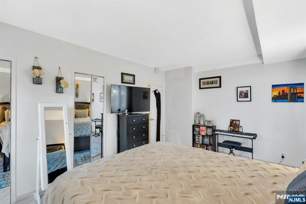 1375 River, Unit LG Edgewater, NJ 07020 - Photo 14 of 18 a bedroom with a bed and a flat screen tv