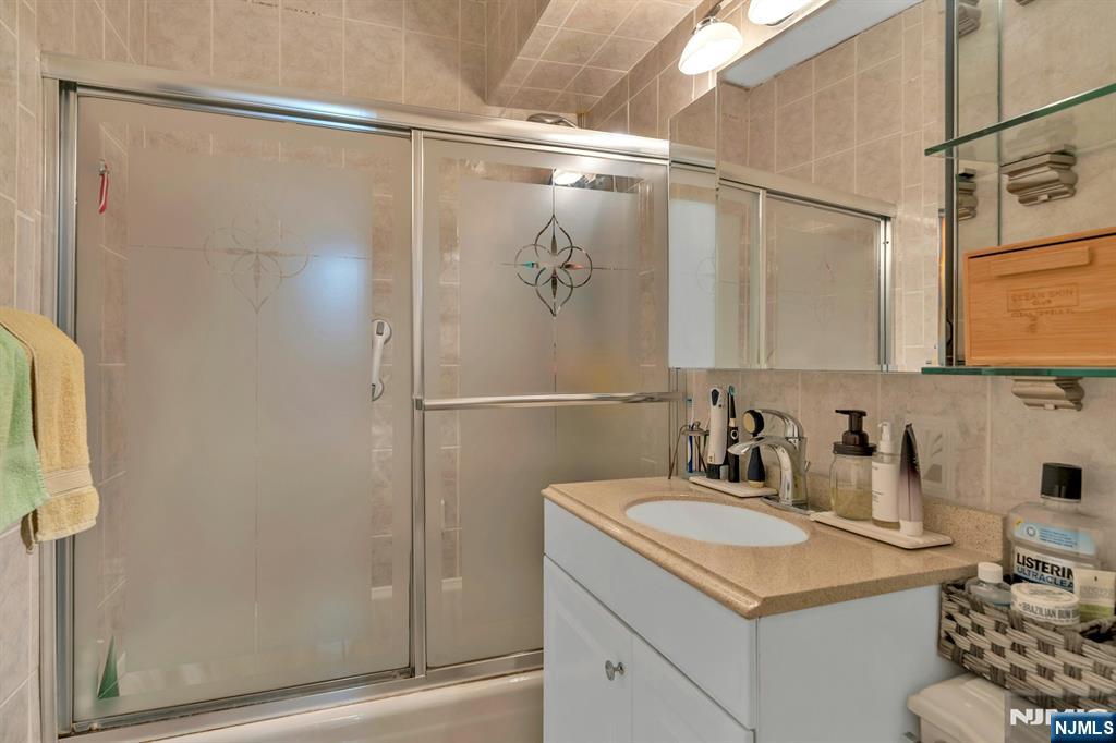 1375 River, Unit LG Edgewater, NJ 07020 - Photo 15 of 18 a bathroom with a sink and a mirror