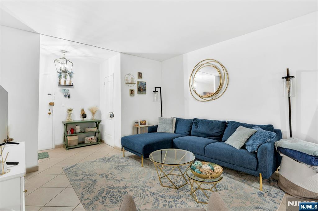 1375 River, Unit LG Edgewater, NJ 07020 - Photo 4 of 18 a living room with furniture and a flat screen tv