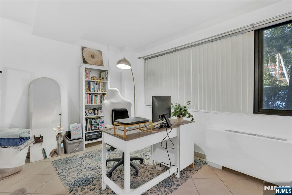 1375 River, Unit LG Edgewater, NJ 07020 - Photo 6 of 18 a workspace with furniture and a potted plant