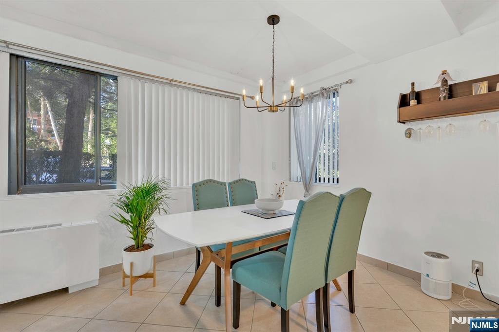 1375 River, Unit LG Edgewater, NJ 07020 - Photo 7 of 18 a view of a dining room with furniture window and wooden floor