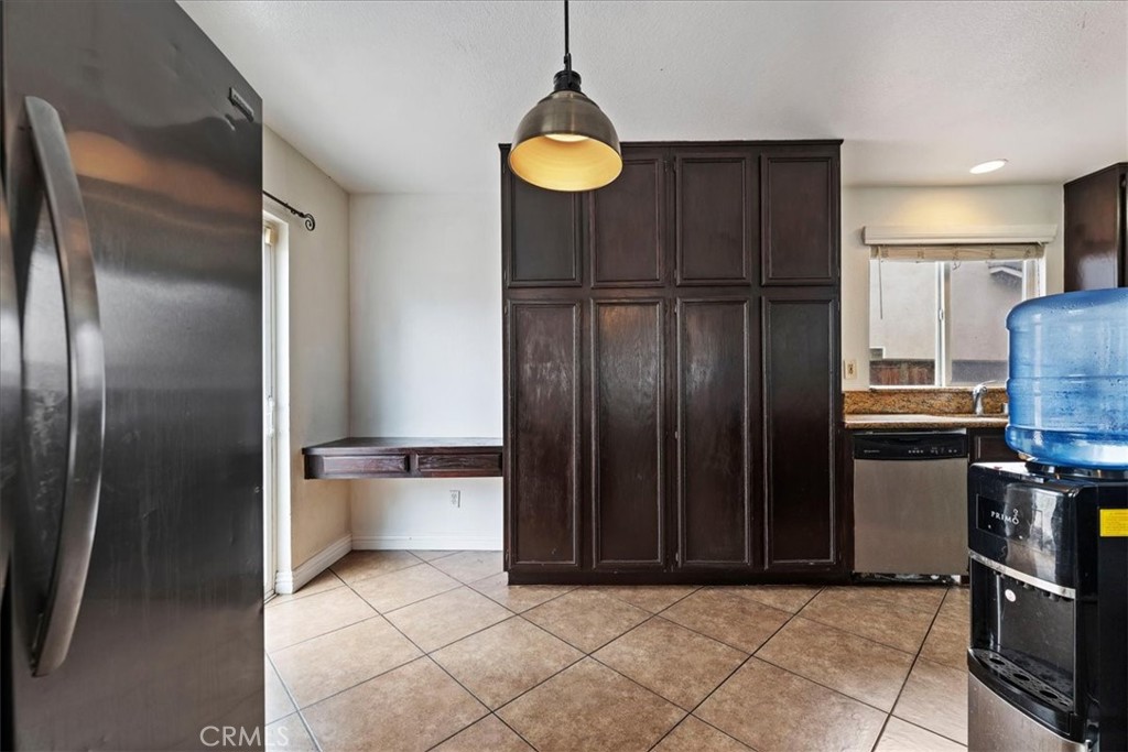 16220 Vía Ultimo Moreno Valley, CA 92551 - Photo 14 of 38 a kitchen with stainless steel appliances granite countertop a refrigerator and a sink