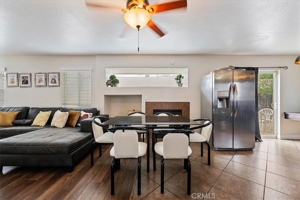 16220 Vía Ultimo Moreno Valley, CA 92551 - Photo 19 of 38 a living room with furniture a rug and a fireplace