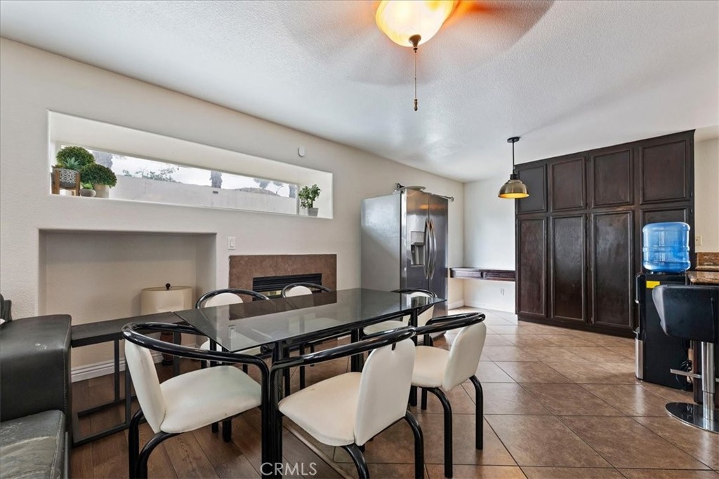 16220 Vía Ultimo Moreno Valley, CA 92551 - Photo 20 of 38 a dining room with furniture and a fireplace