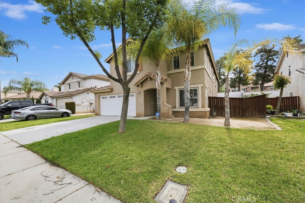 16220 Vía Ultimo Moreno Valley, CA 92551 - Photo 2 of 38 a front view of a house with a yard