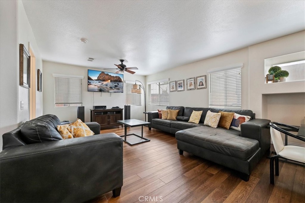 16220 Vía Ultimo Moreno Valley, CA 92551 - Photo 21 of 38 a living room with furniture and wooden floor