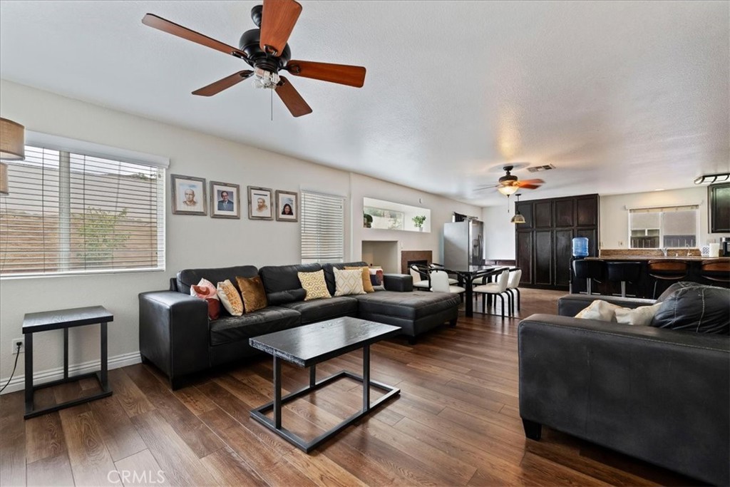 16220 Vía Ultimo Moreno Valley, CA 92551 - Photo 23 of 38 a living room with furniture a ceiling fan and a window