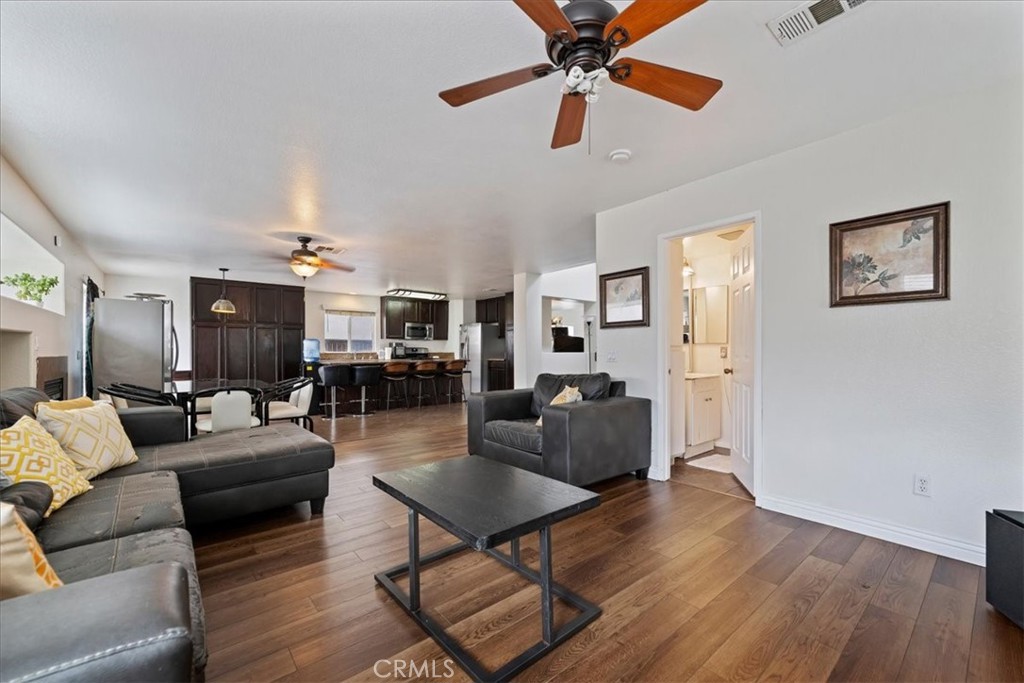 16220 Vía Ultimo Moreno Valley, CA 92551 - Photo 24 of 38 a living room with furniture and wooden floor