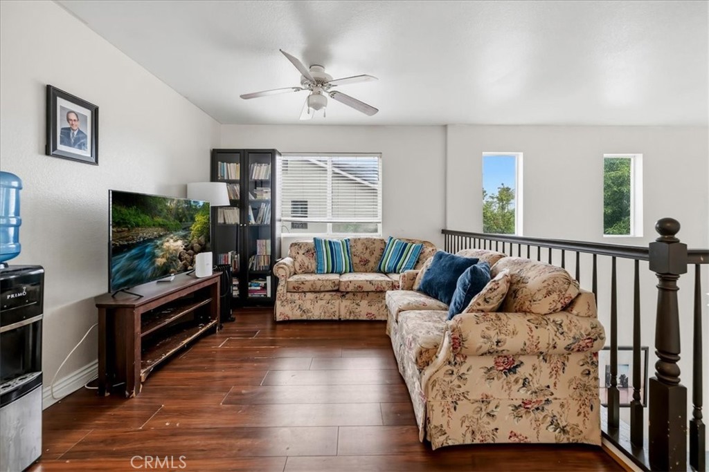 16220 Vía Ultimo Moreno Valley, CA 92551 - Photo 29 of 38 a living room with furniture and a flat screen tv