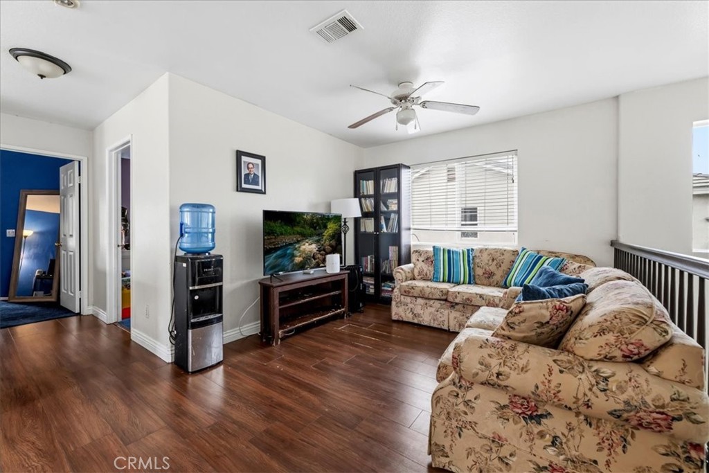 16220 Vía Ultimo Moreno Valley, CA 92551 - Photo 30 of 38 a living room with furniture and a flat screen tv
