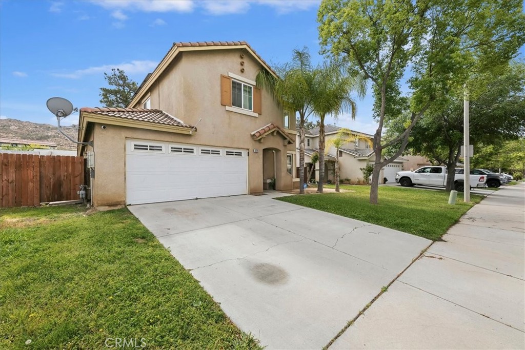 16220 Vía Ultimo Moreno Valley, CA 92551 - Photo 3 of 38 a view of a white house with a yard