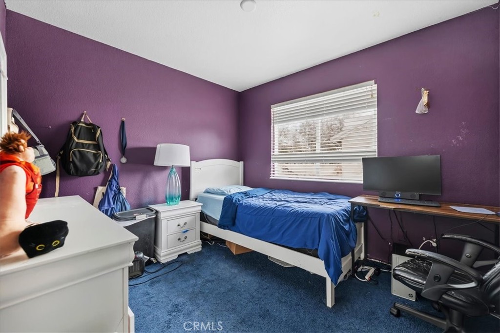 16220 Vía Ultimo Moreno Valley, CA 92551 - Photo 32 of 38 a bedroom with a bed and a flat screen tv