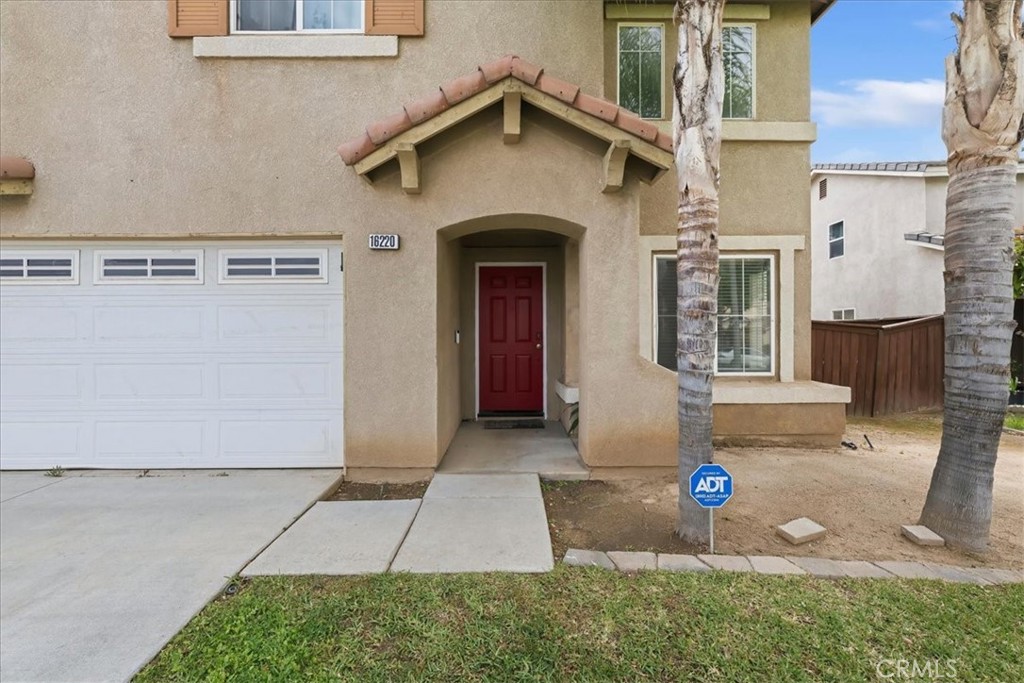16220 Vía Ultimo Moreno Valley, CA 92551 - Photo 4 of 38 a front view of a house with a yard