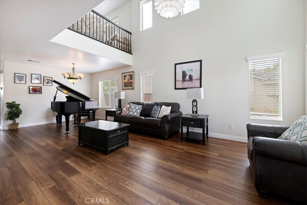 16220 Vía Ultimo Moreno Valley, CA 92551 - Photo 6 of 38 a living room with furniture and wooden floor