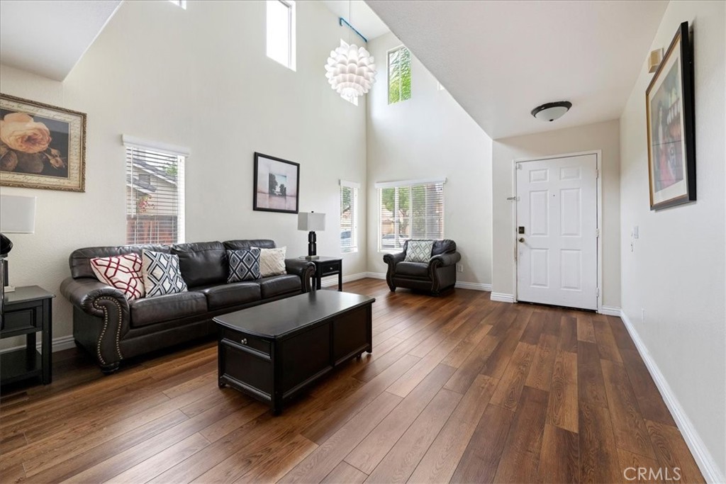 16220 Vía Ultimo Moreno Valley, CA 92551 - Photo 7 of 38 a living room with furniture and a wooden floor