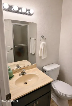 a bathroom with a sink toilet and mirror