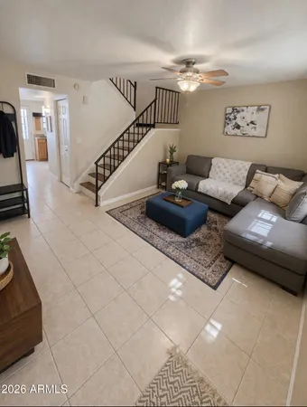 a living room with furniture and stairs