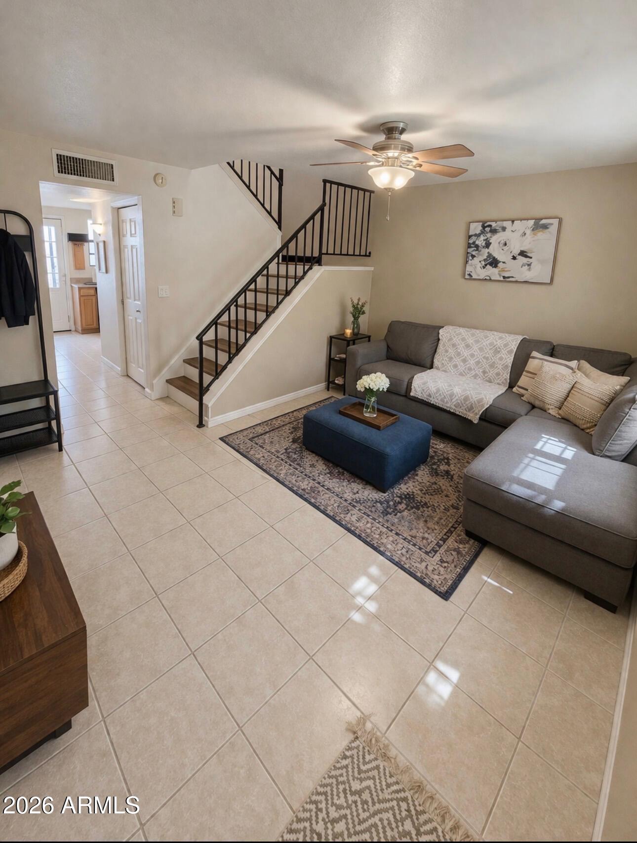 4835 East McNeil Street, Unit 2 Phoenix, AZ 85044 - Photo 2 of 21 a living room with furniture and stairs