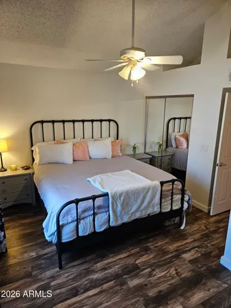a large bed sitting in a bedroom next to a chandelier