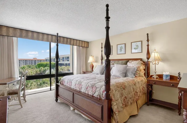 a bedroom with a bed and large window