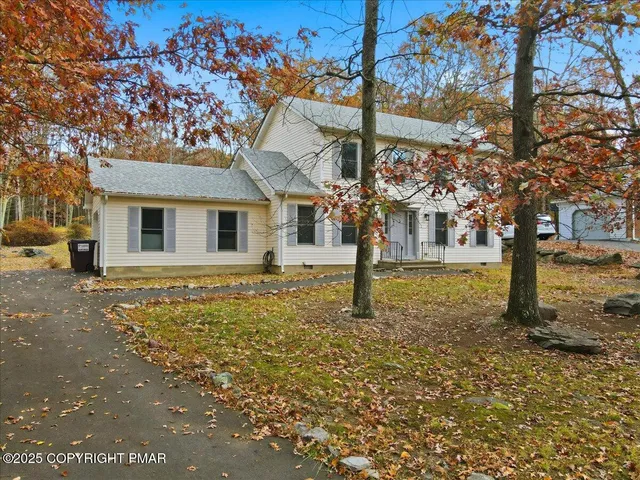 a view of a house with a tree in the background
