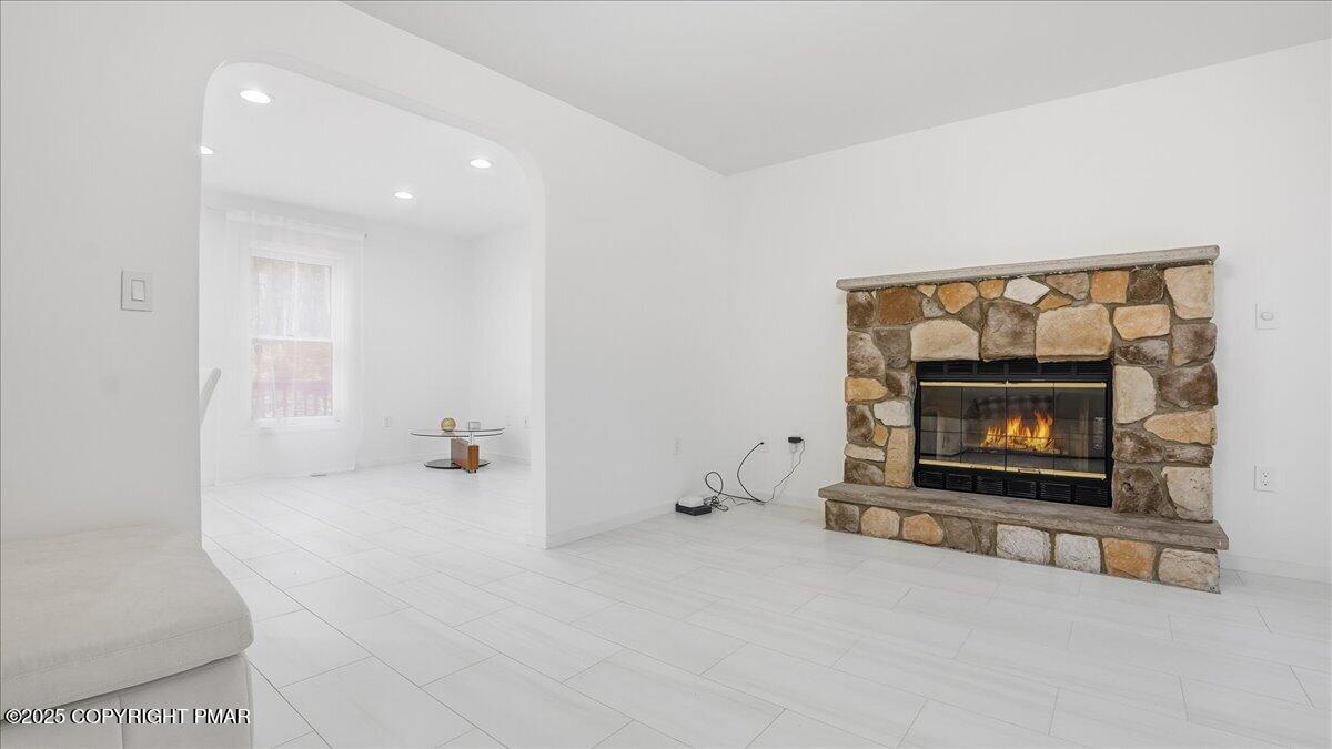 2312 Cramer Court Bushkill, PA 18324 - Photo 14 of 107 a living room with furniture and a fireplace