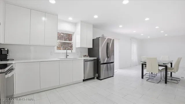 a view of a room with furniture and wooden floor