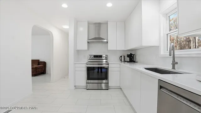 a kitchen with stainless steel appliances kitchen island granite countertop a table and chairs