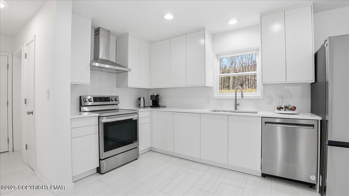2312 Cramer Court Bushkill, PA 18324 - Photo 24 of 107 a kitchen with stainless steel appliances a sink stove and cabinets
