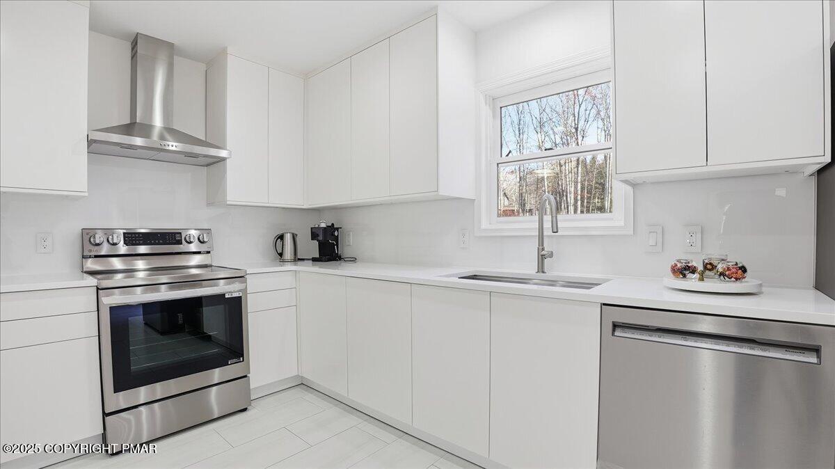 2312 Cramer Court Bushkill, PA 18324 - Photo 25 of 107 a kitchen with stainless steel appliances granite countertop a sink stove and cabinets