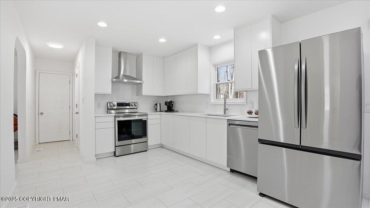 2312 Cramer Court Bushkill, PA 18324 - Photo 27 of 107 a kitchen with stainless steel appliances a refrigerator sink and cabinets