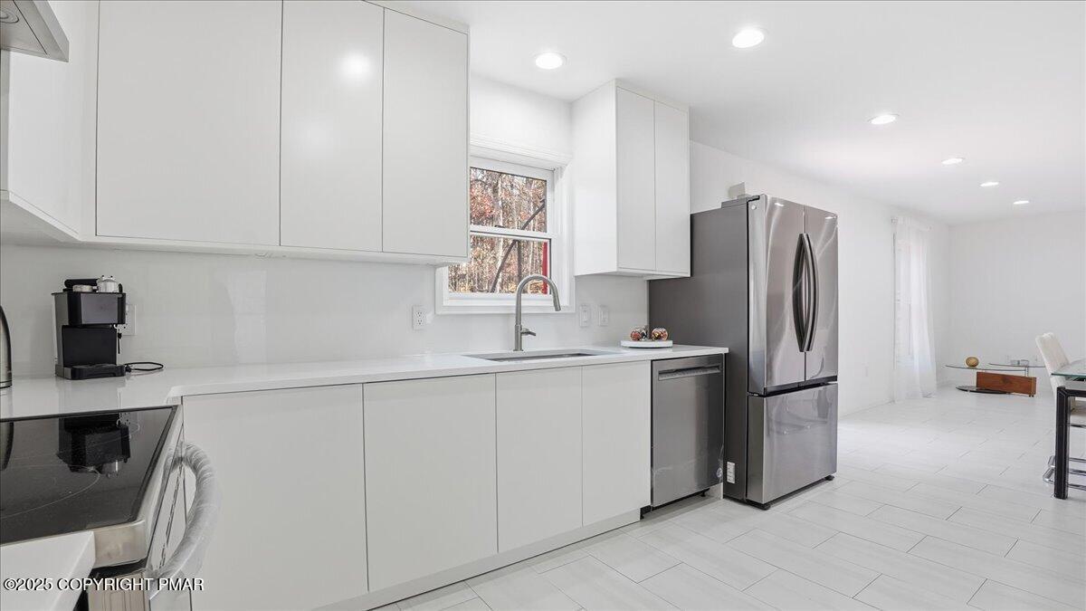 2312 Cramer Court Bushkill, PA 18324 - Photo 28 of 107 a kitchen with stainless steel appliances a refrigerator sink and microwave