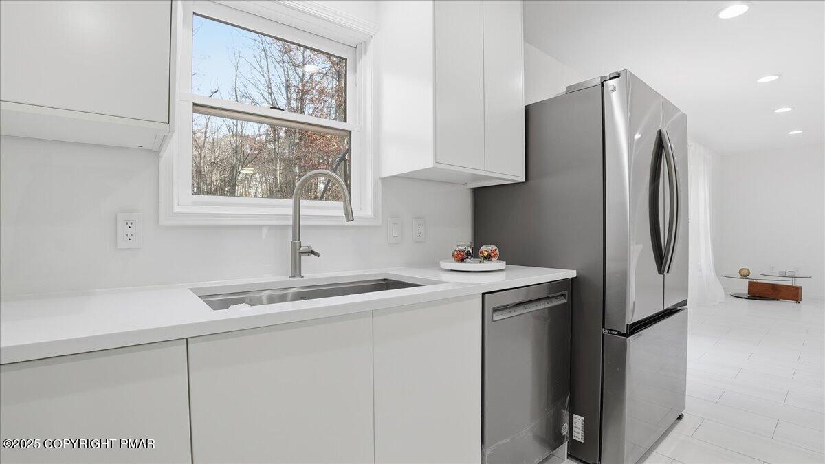 2312 Cramer Court Bushkill, PA 18324 - Photo 29 of 107 a kitchen with stainless steel appliances granite countertop a refrigerator and a sink