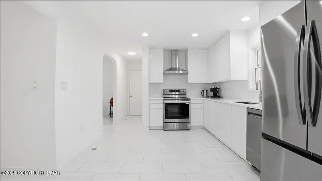 a bathroom with a sink a toilet a mirror and shower