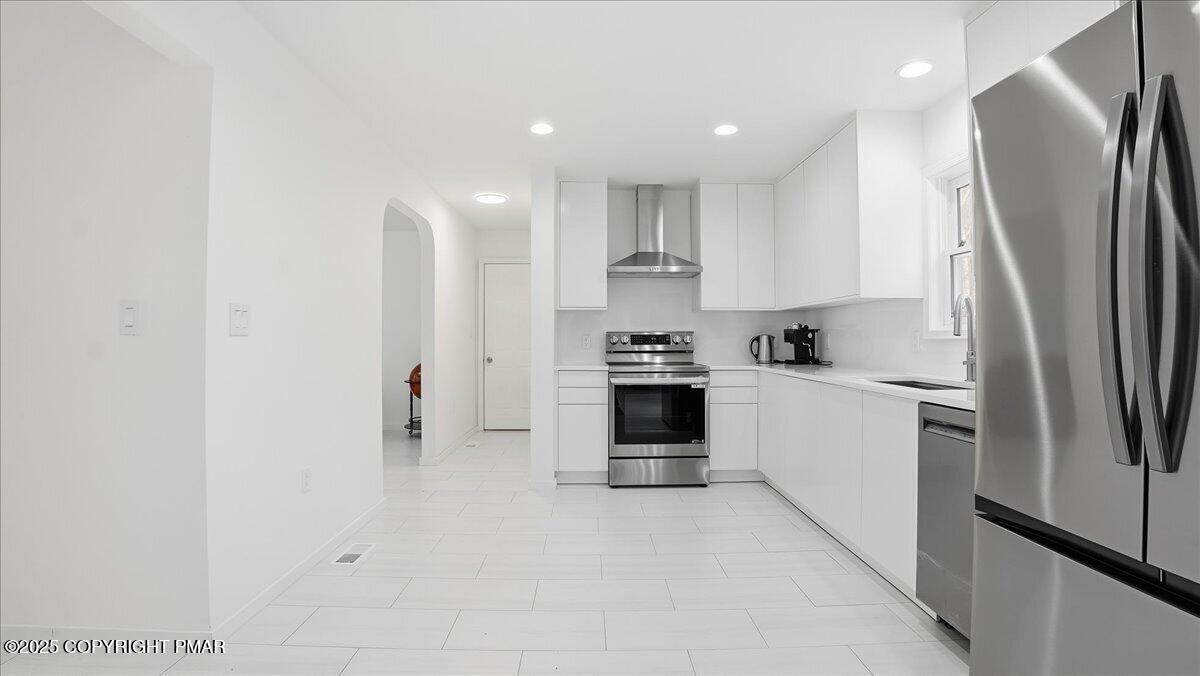 2312 Cramer Court Bushkill, PA 18324 - Photo 32 of 107 a kitchen with stainless steel appliances a refrigerator sink and stove