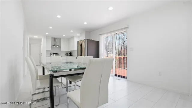 a backyard of a house with table and chairs