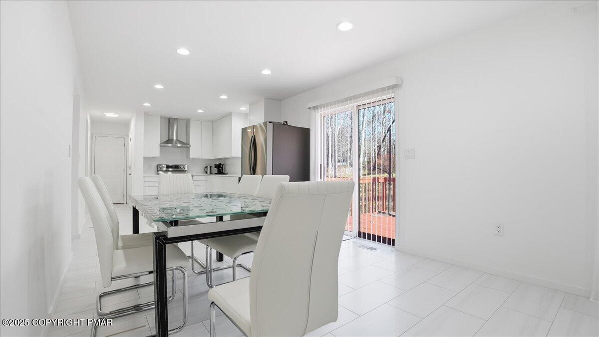 2312 Cramer Court Bushkill, PA 18324 - Photo 40 of 107 a kitchen with stainless steel appliances kitchen island granite countertop a table and chairs