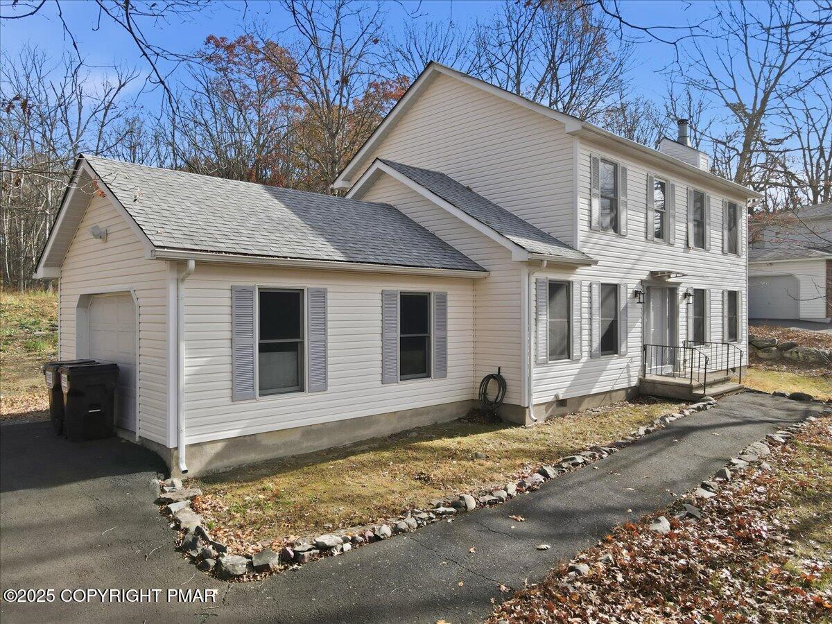 2312 Cramer Court Bushkill, PA 18324 - Photo 4 of 107 a view of a white house with a large tree next to a yard