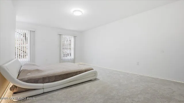 a view of a house with a yard covered in snow