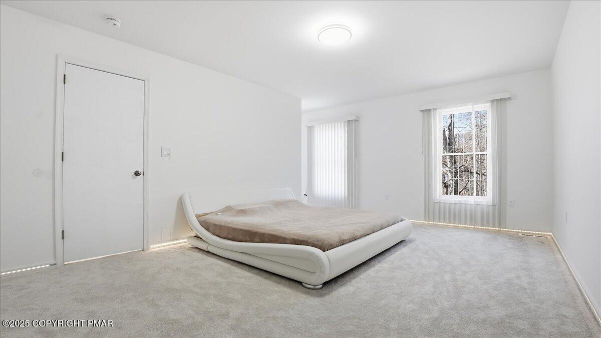 2312 Cramer Court Bushkill, PA 18324 - Photo 51 of 107 a spacious bedroom with a bed and a window